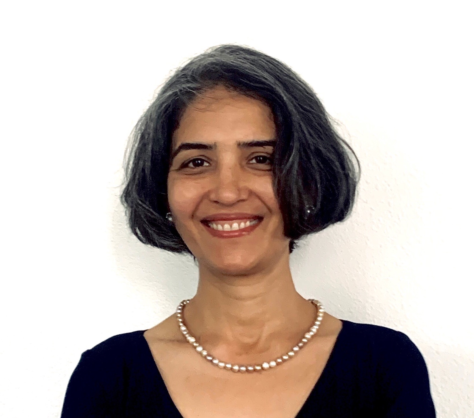 Anjali Arora headshot. Woman with short dark hair, wearing black top.