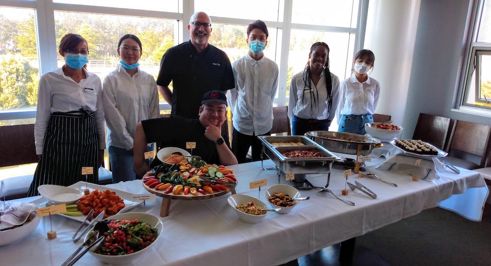 Center for Ethical and Sustainable Business 2022-2023 Vista Room Vegan Event, restaurant staff standing around buffet table full of food