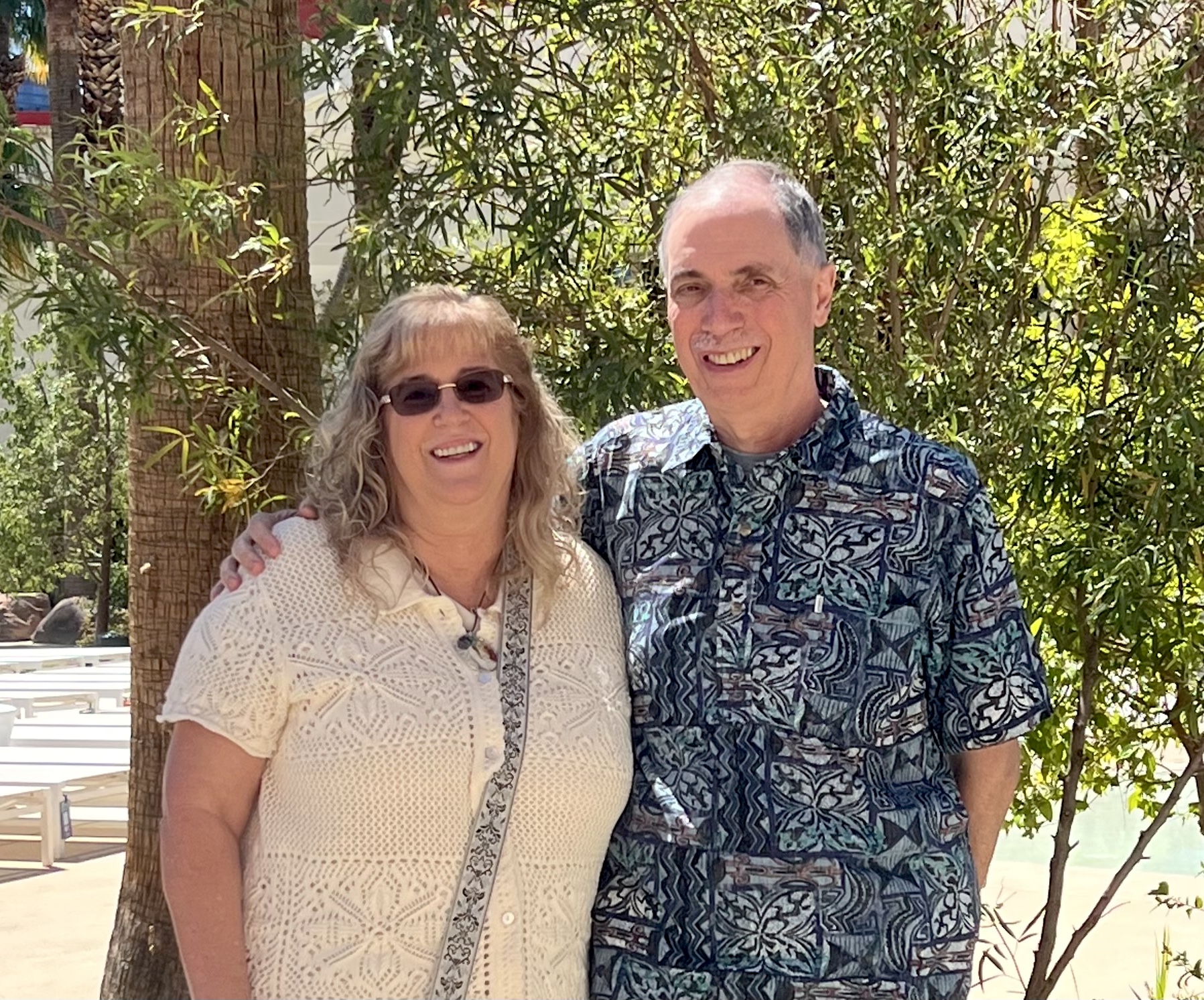 SFSU donors, Charlie and Diane Overmire. A couple dressed casually standing outside with trees in background.