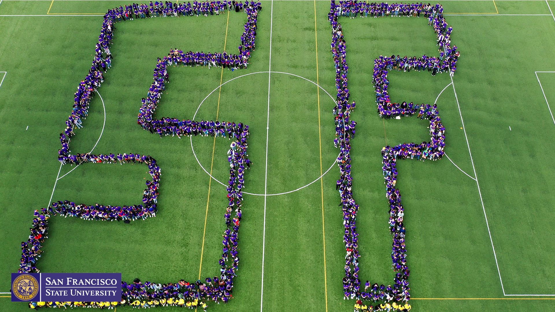 aerial shot of SF spelled out by students on campus lawn