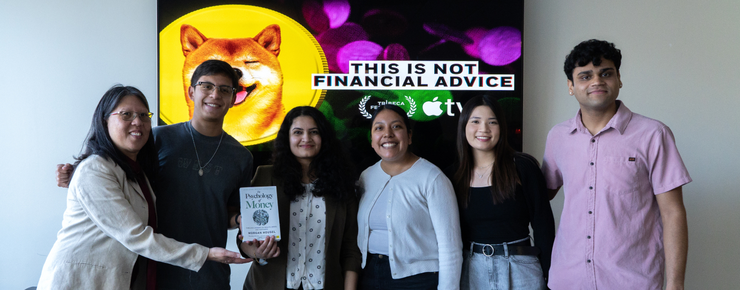 SFSU Economics faculty and students standing in front of TV monitor 