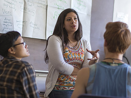 A Professor is talking to a group of people in a classroom.