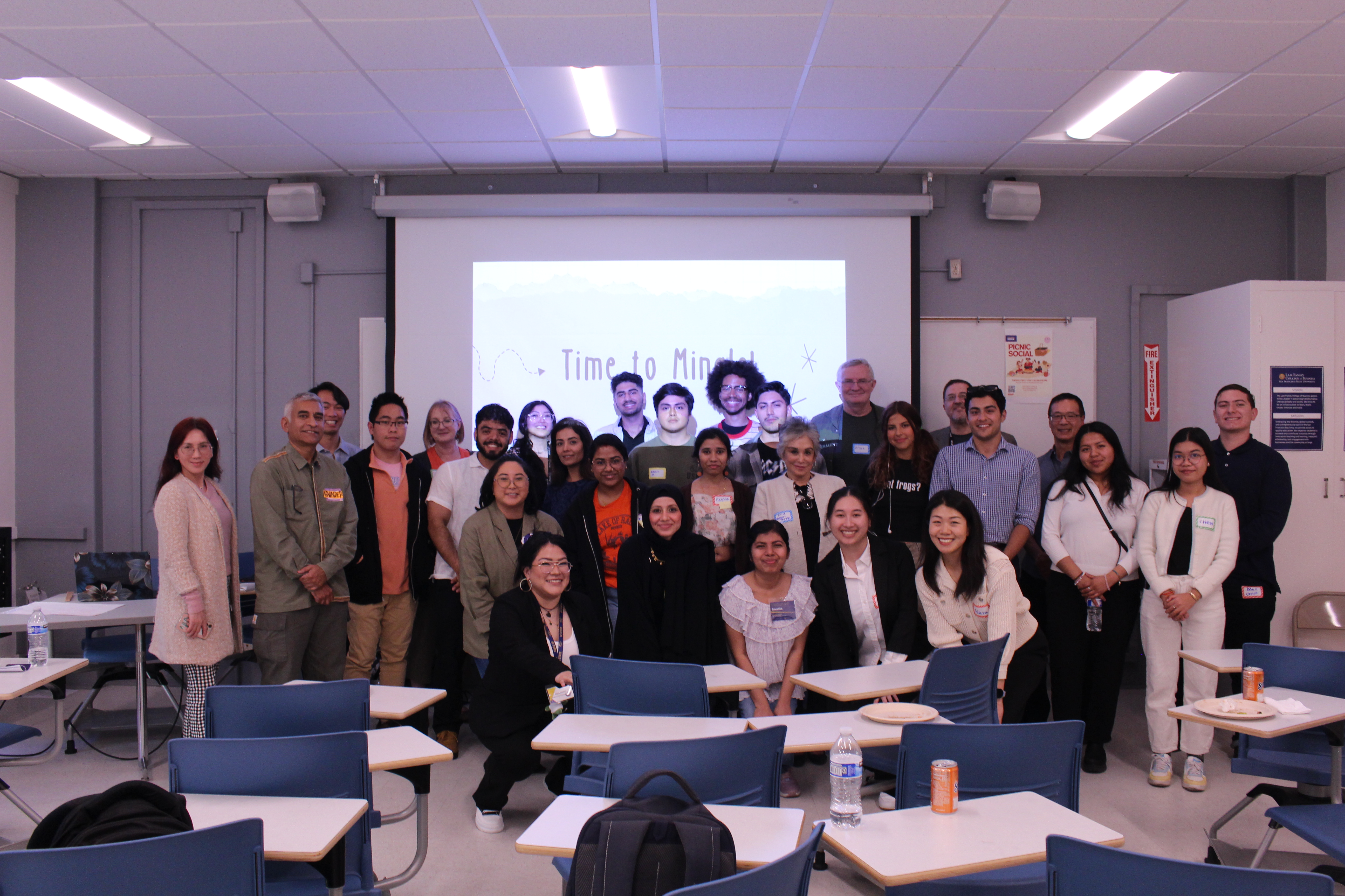 Mentorship Program group photo with students, alumni and faculty in a classroom