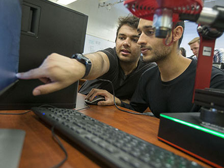 Two students looking at a computer screen.