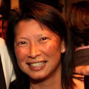 June Ou, headshot of woman smiling, with short dark hair