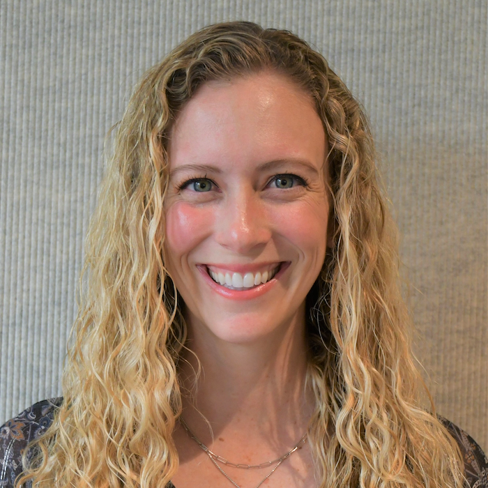Kerry Deichen, woman smiling, with long blonde hair wearing colorful top