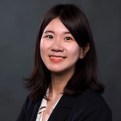 Kyungin Ryu headshot, smiling woman with dark brown hair, wearing black blazer