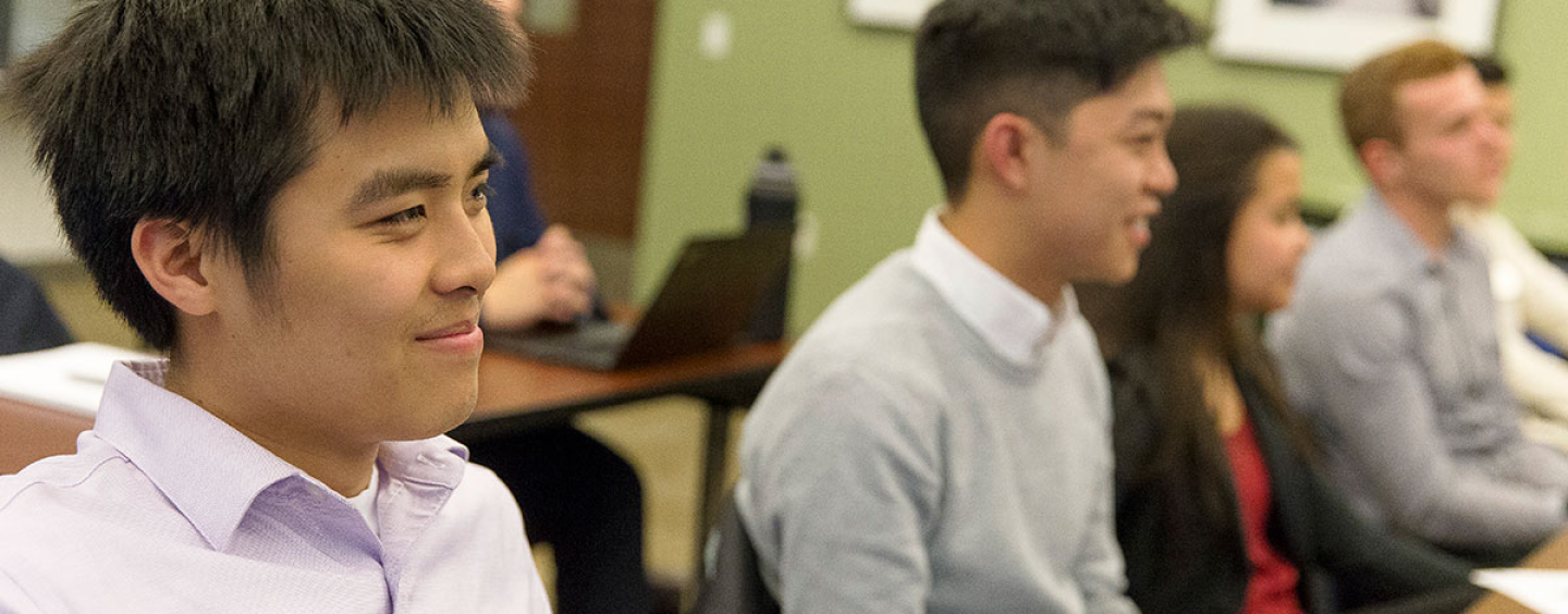 SFSU students sitting at desks in a classroom.