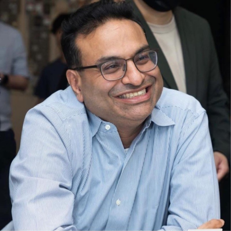 Laxman Narasimhan, C-suite executive with dark short hair, eyeglasses, wearing light blue button-down collared shirt
