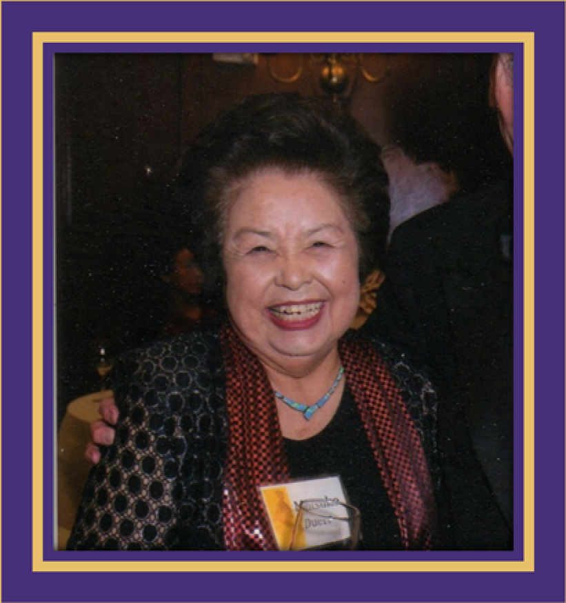 Mitsuko Saito Duerr Endowed Scholarship Donor - woman with black hair smiling, at a gathering with other people in background