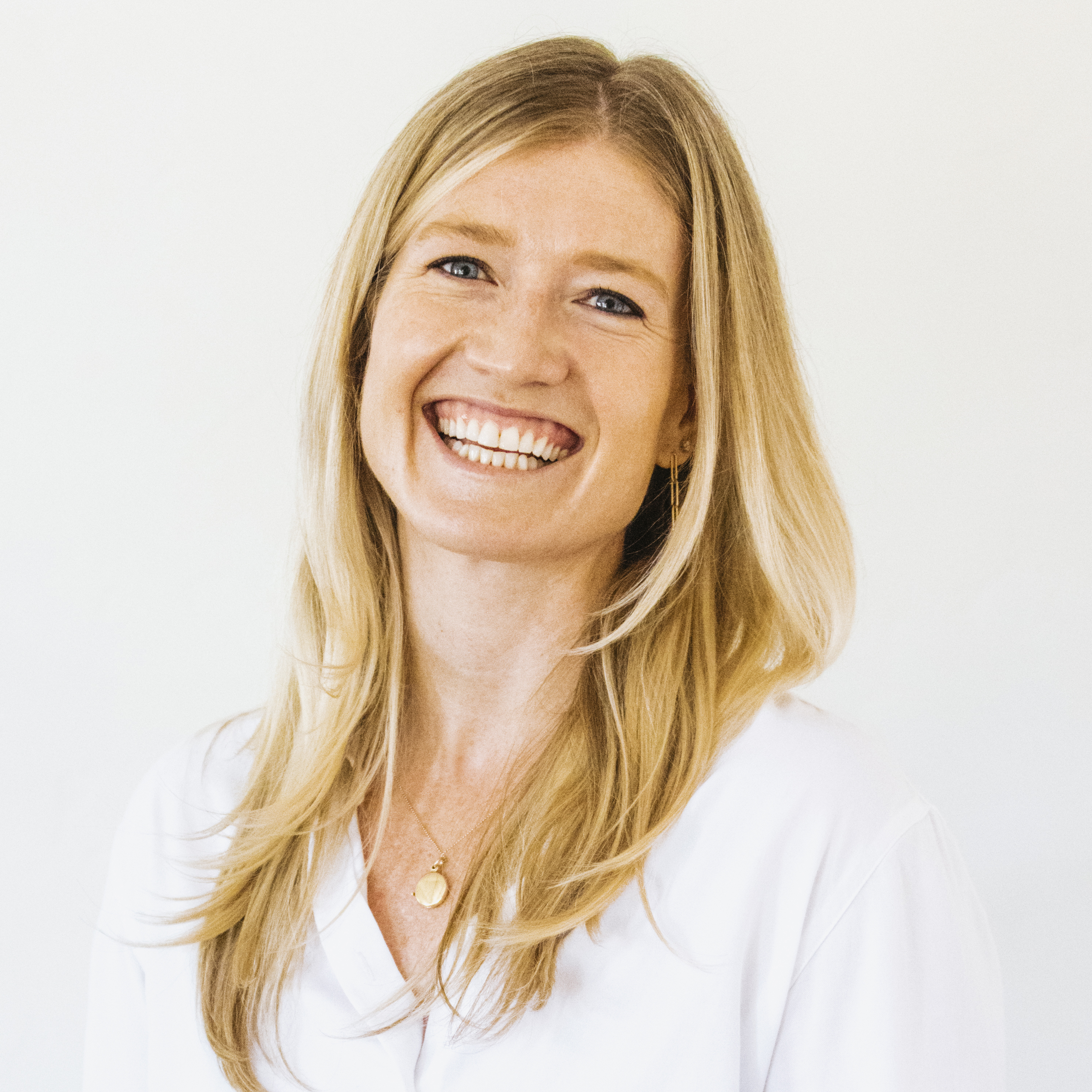 Rebecca Tierney, woman with long blonde hair, smiling, wearing a white top