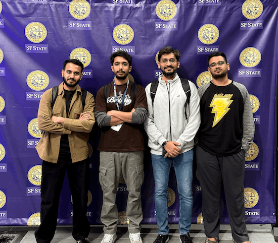 Four students who competed in 2025 SF Hacks, standing in front of SFSU-logo backdrop