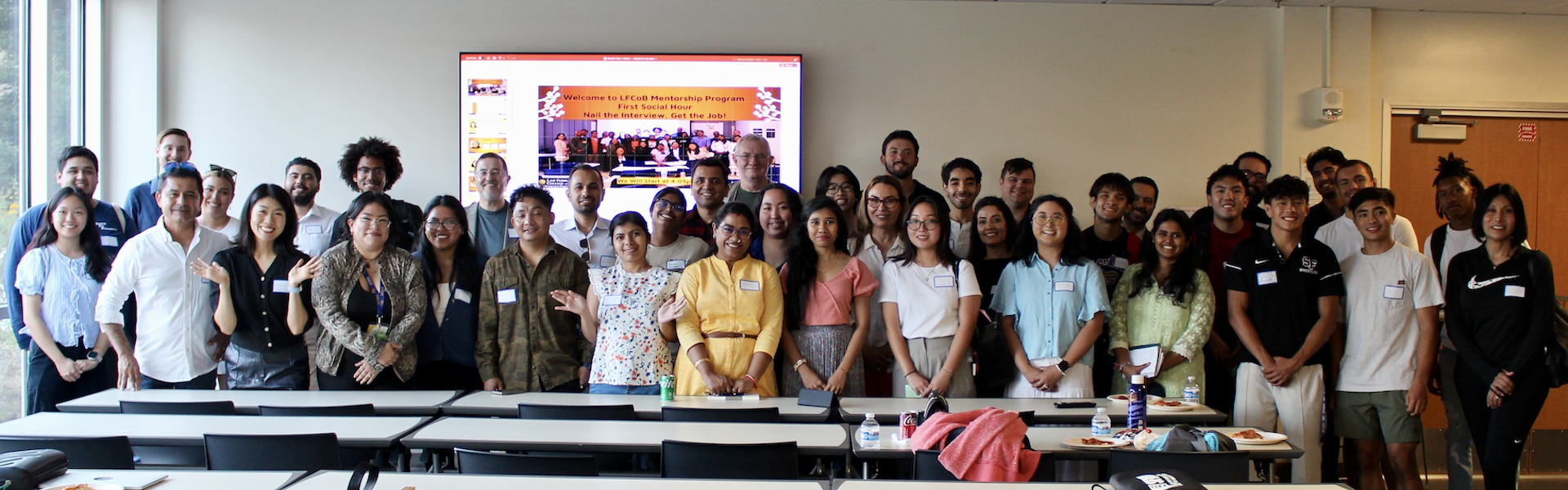 Mentorship Program group photo with students, alumni and faculty in a classroom