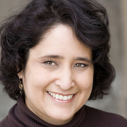 Theresa Roeder, SFSU decision sciences professor, headshot, smiling, with short dark hair, wearing brown turtleneck top