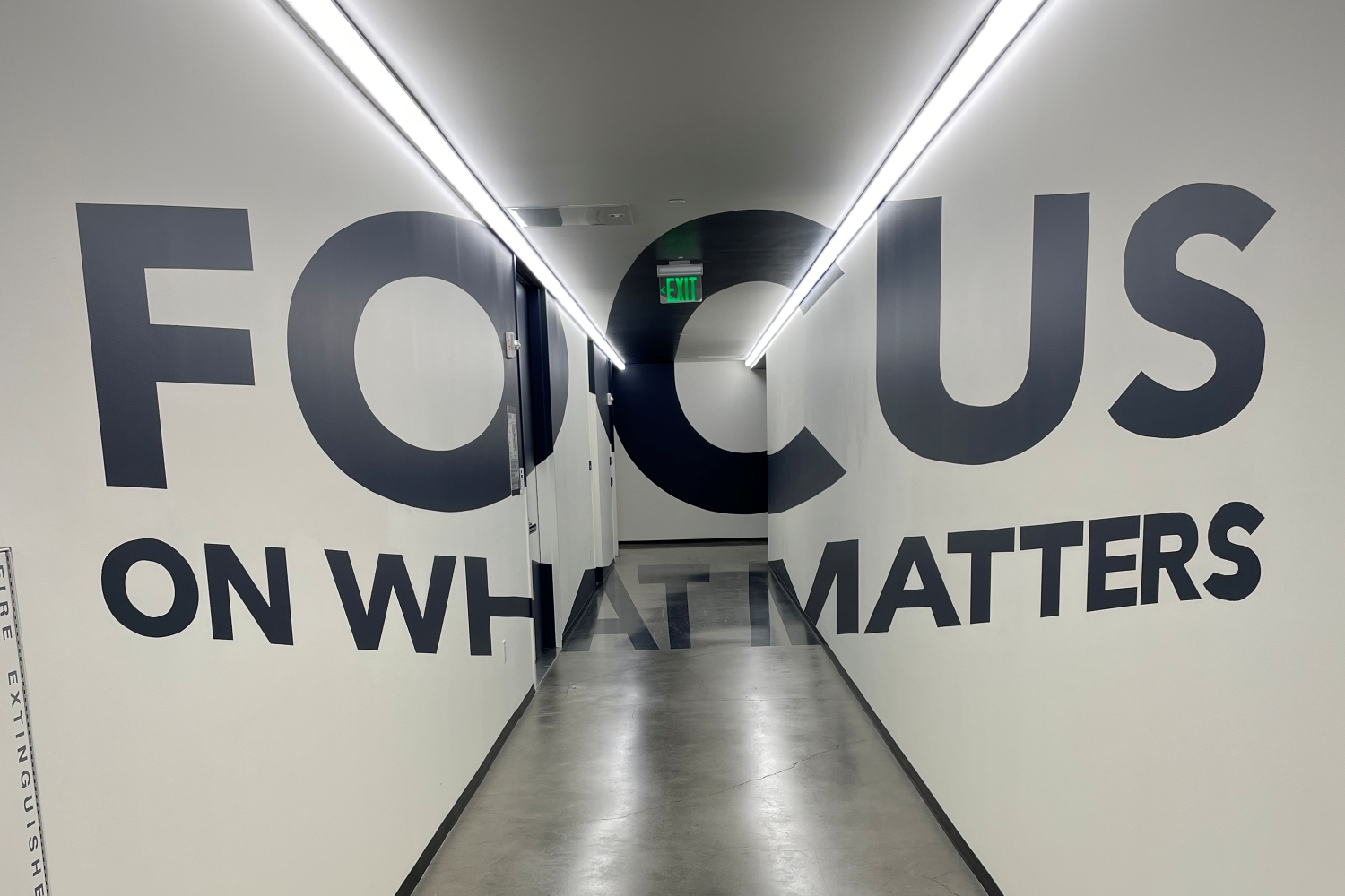 WELF 2024 (2): mural on white walls that says "Focus on what matters"