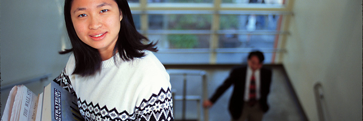 Student smiling on stairwell