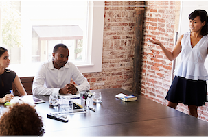 Women and men around a conference table