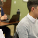 SFSU students sitting at desks in a classroom.